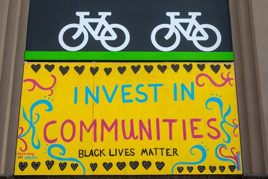 Community mural advocating for Black Lives Matter and investment in communities. Black Lives Matter protest activism. Oakland, California, USA, 18 June 2020