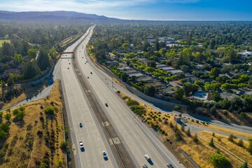 Highway 85 traffic flows through residential area. Cars travel on freeway, surrounded by homes and...