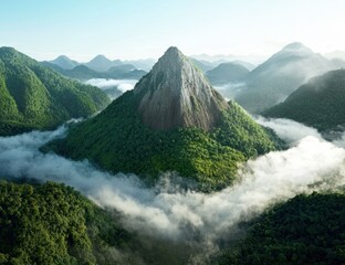 Lush green mountain rising above the clouds.