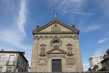 Stone church facade, intricate details. Braga, Portugal. Religious architectural masterpiece. Symbol of faith, community heritage.
