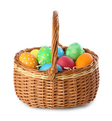 Happy Easter. Bright painted eggs in wicker basket isolated on white