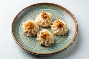 A delectable plate of delicate steamed dumplings, each topped with a savory, star-shaped garnish, presented on a stylish teal ceramic dish.