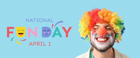 Smiling young man in clown disguise on light blue background. Banner for National Fun Day