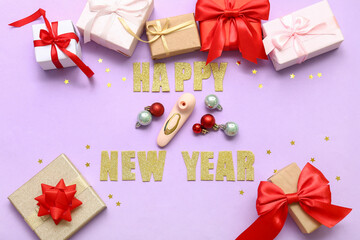 Vibrator with gift boxes and text HAPPY NEW YEAR on lilac background