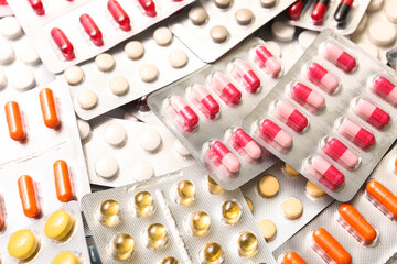 Blister packs with different pills as background