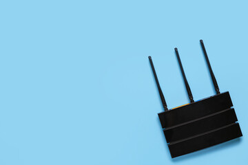 Modern wi-fi router on blue background