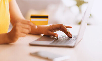 Online Shopping And Easy Payment. Close up cropped view of black lady holding credit card and using...
