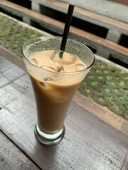 a glass of Spanish latte cortado with ice and a nice cold coffee taste in minimal style cafe, Cool summer drink.