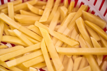 Batonnet cut potatoes soaked in water to remove starch and make crispy fries