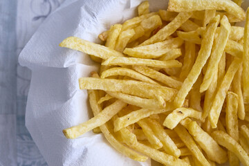 Paper towel bowl filled with crispy and golden homemade potato french fries
