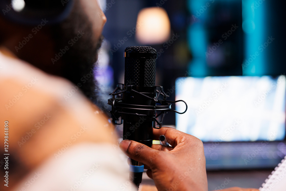 Poster closeup of african american person with a beard speaking into a microphone creating asmr content. de