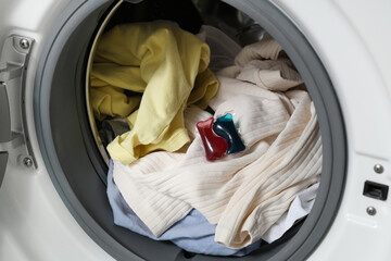 Open washing machine with dirty laundry, closeup