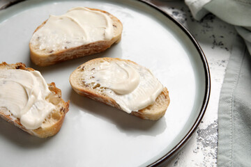 Plate of tasty bruschetta with processed cheese on grunge background, closeup