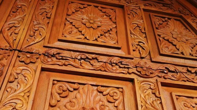 Ornate golden wooden door, luxurious and festive Element of Hindu culture. Close up view.