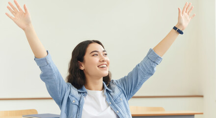 A woman is smiling and waving her hands in the air
