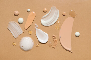 Composition with samples of different cosmetic products on color background