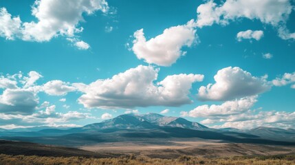 Obraz premium Mountain landscape with blue sky and clouds. Possible use Stock photo for nature, travel, or environment themes