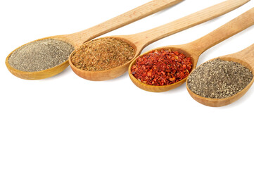 Wooden spoons with different spices isolated on white background