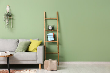 Interior of living room with wooden ladder and sofa