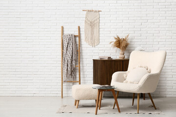 Interior of living room with wooden ladder, armchair and ottoman
