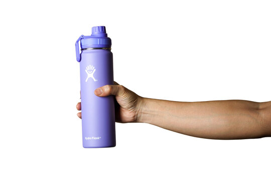 Bangbon Bangkok,Thailand-16 March 2025:Close-up of male hand, holding a hydro flask hydro flask light purpl eco-thermo steel reusable water bottle. white pastel background Free from plastic Zero waste