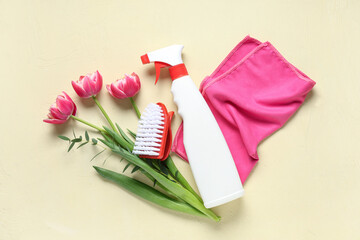 Cleaning supplies with spring flowers on beige background