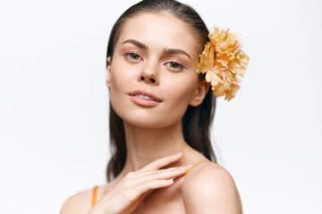 Elegant woman with flower, soft expression in studio, showcasing beauty and freshness, perfect for...