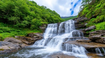 Fototapeta premium Serenity of Cascading Waterfalls in Lush Green Landscape