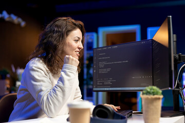 Cheerful computer engineer satisfied after futureproofing company network from downtimes and...
