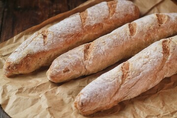 fresh cut baguettes on the wodden tray with butter. sourdough baguettes. healthy food.
