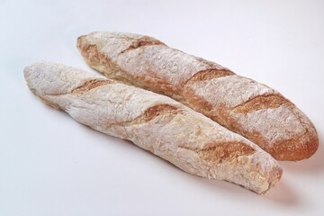 fresh cut baguettes on white background. sourdough baguettes. healthy food.
