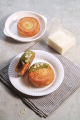 Cromboloni is modified croissant. Round puff pastry filled with cream, and glazed with white, milk chocolate or matcha. Crunchy and soft in the same time.
