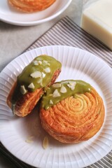Cromboloni is modified croissant. Round puff pastry filled with cream, and glazed with white, milk chocolate or matcha. Crunchy and soft in the same time.
