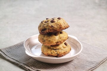 Soft Chocochip Cookies on white plate, served with milk.
