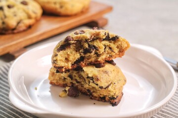 Soft Chocochip Cookies on white plate, served with milk.
