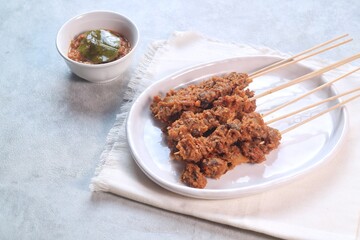 Clam Satay. Sate Kerang. Made from clams, chili, garlic, salt, spices and coconut. 

