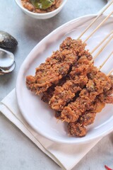 Clam Satay. Sate Kerang. Made from clams, chili, garlic, salt, spices and coconut. 
