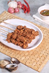 Clam Satay. Sate Kerang. Made from clams, chili, garlic, salt, spices and coconut. 
