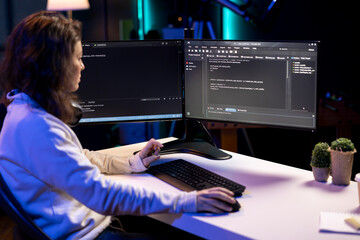 Cybersecurity expert using computer to look for company security vulnerabilities and prevent...