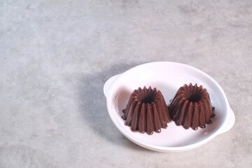 Homemade Dessert Puding coklat or chocolate pudding on white background, have a sweet taste. Made from jelly, cocoa powder, sugar, and milk.
