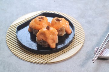 Dimsum with Japanese Mentai Sauce. Served on plate.
