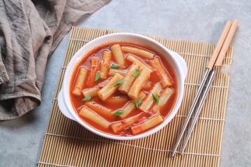 Delicious Korean Cuisine spicy tteokbokki or ttopoki on white plate. 
