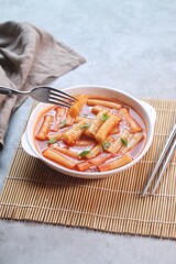 Delicious Korean Cuisine spicy tteokbokki or ttopoki on white plate. 
