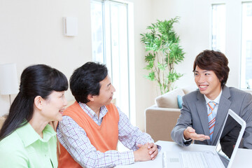 Obraz premium 営業マンと打ち合わせをする夫婦