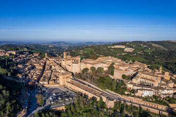 Drone cityscape of Urbino with the Ducal Palace: one of the most important monuments in Italy, listed as UNESCO World Heritage Site (Marche, Italy).