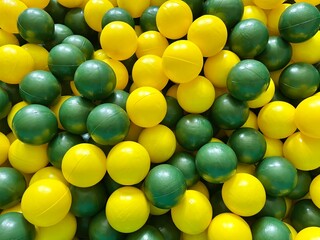 close up of yellow and green plastic ball toys