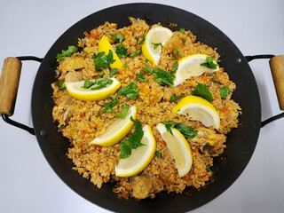 Homemade Spanish meal. Paella wiith Asian Clams and Ham Cubes. Chicken bone broth, gammon and lala aka Asian clams