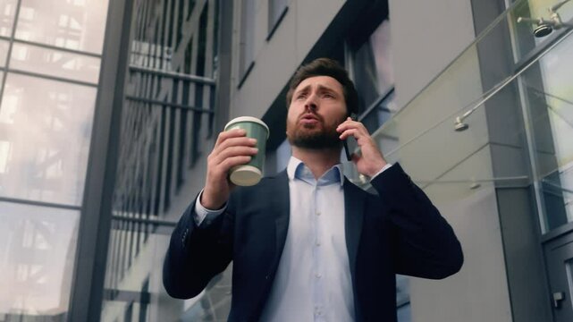 Angry mad furious talking yelling call male employer problem trouble entrepreneur Caucasian man hold coffee business guy businessman walking in city conflict talk mobile phone job startup quarrel bad