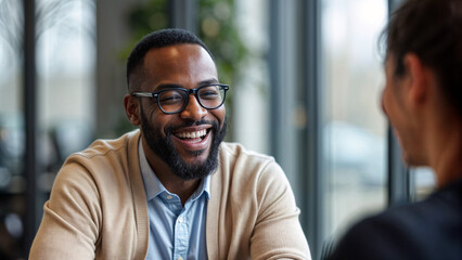 Professional and Supportive Counseling Session With Laughing Black Male in Glasses