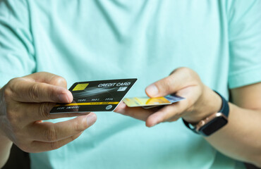 woman holding credit cards and he is choosing a credit card to pay and spend Payment for goods via...